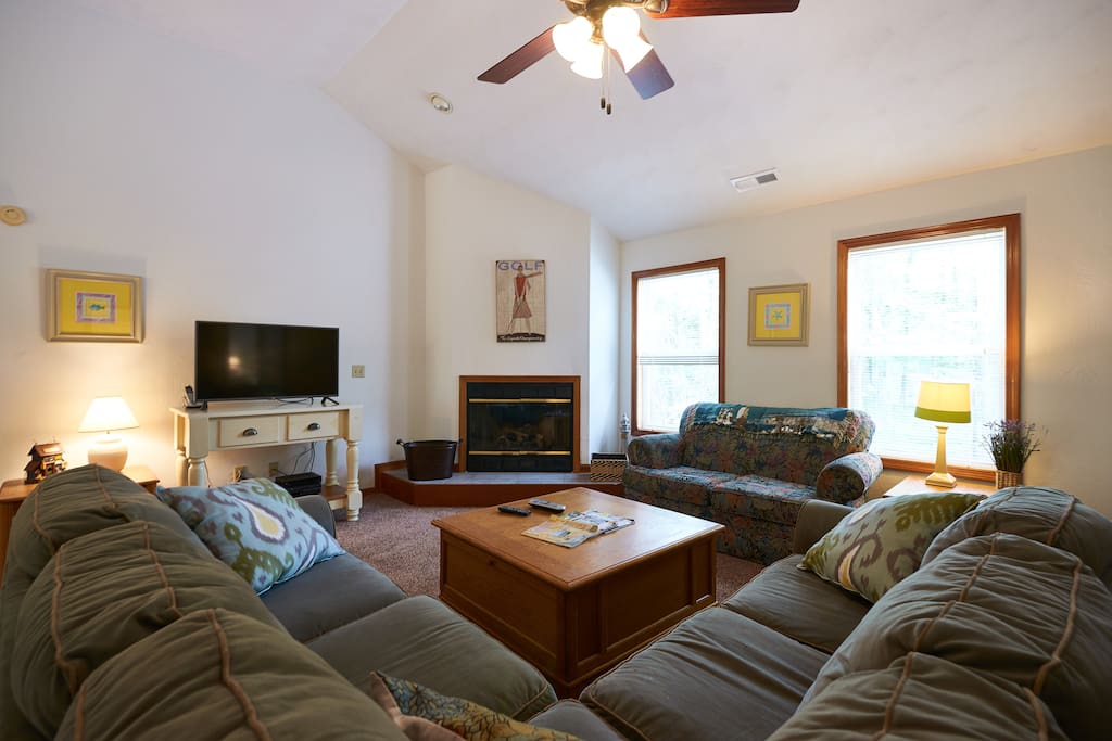 Comfortable living area with sectional sofa and love seat.