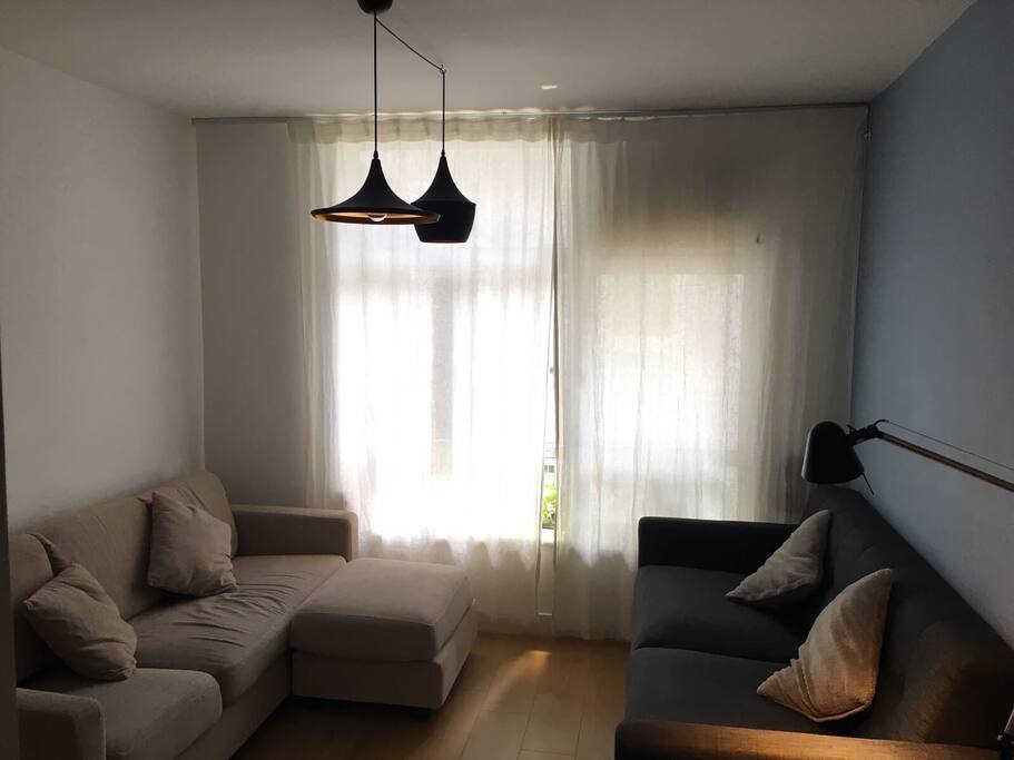 The living room with the linen curtains