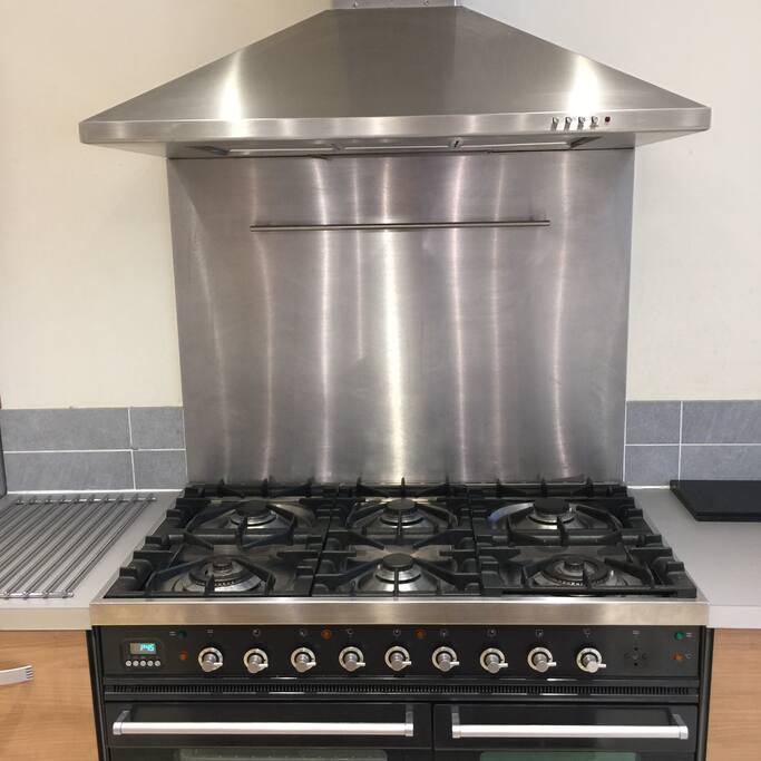Large range oven with 6 burners. Also large american style fridge freezer.