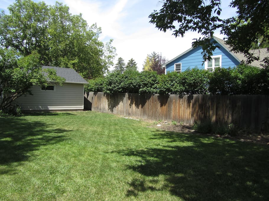 Fully fenced grassy backyard