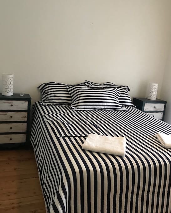 Master bedroom with queen bed and sunroom and built in wardrobe