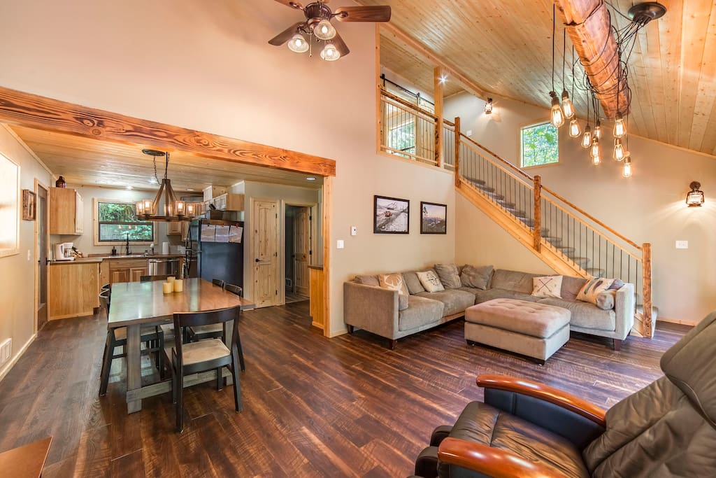 Huge soaring ceilings in the main living room with large couch and massage station.