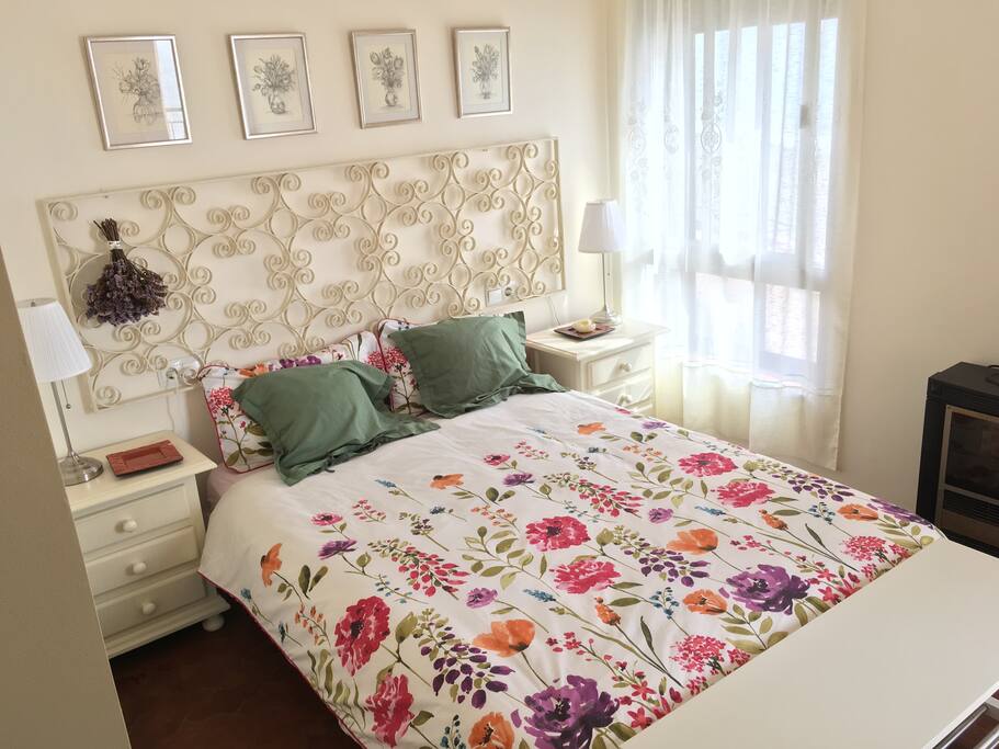 Main room with double bed and next to the window where you can see the sunrise.It also have acces to the balcony