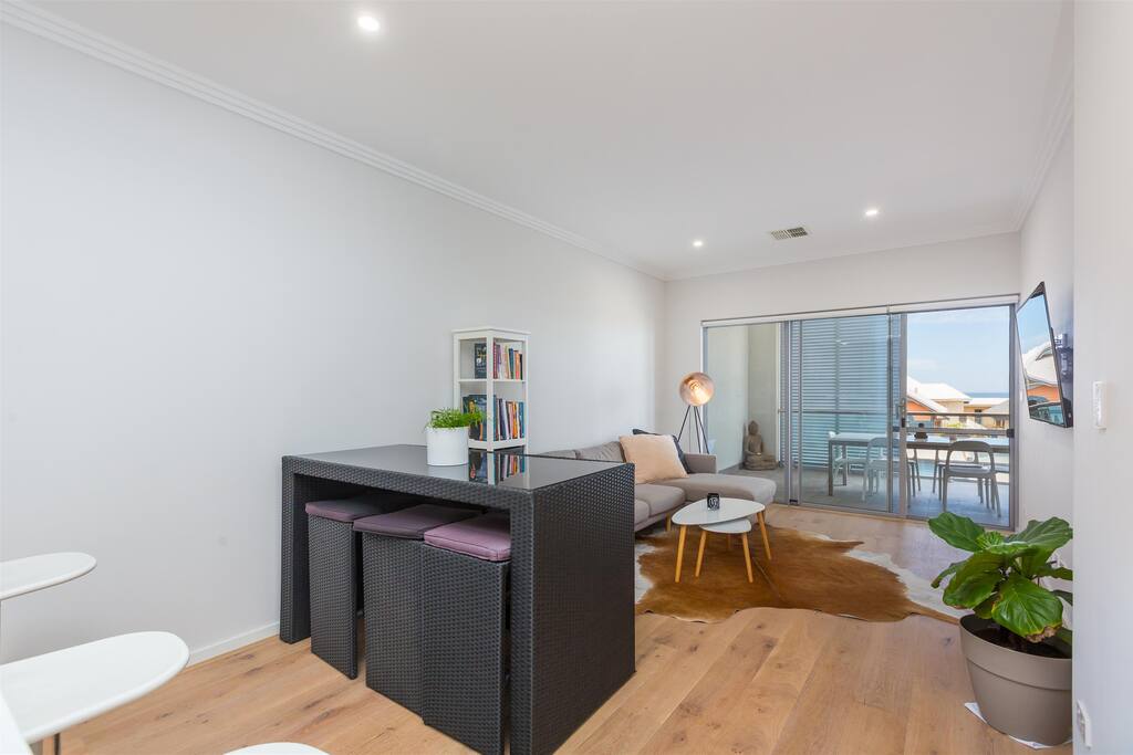Dining/Living spaces with stunning timber flooring, HUGE Sony plasma smart TV with Netflix fitted to the wall