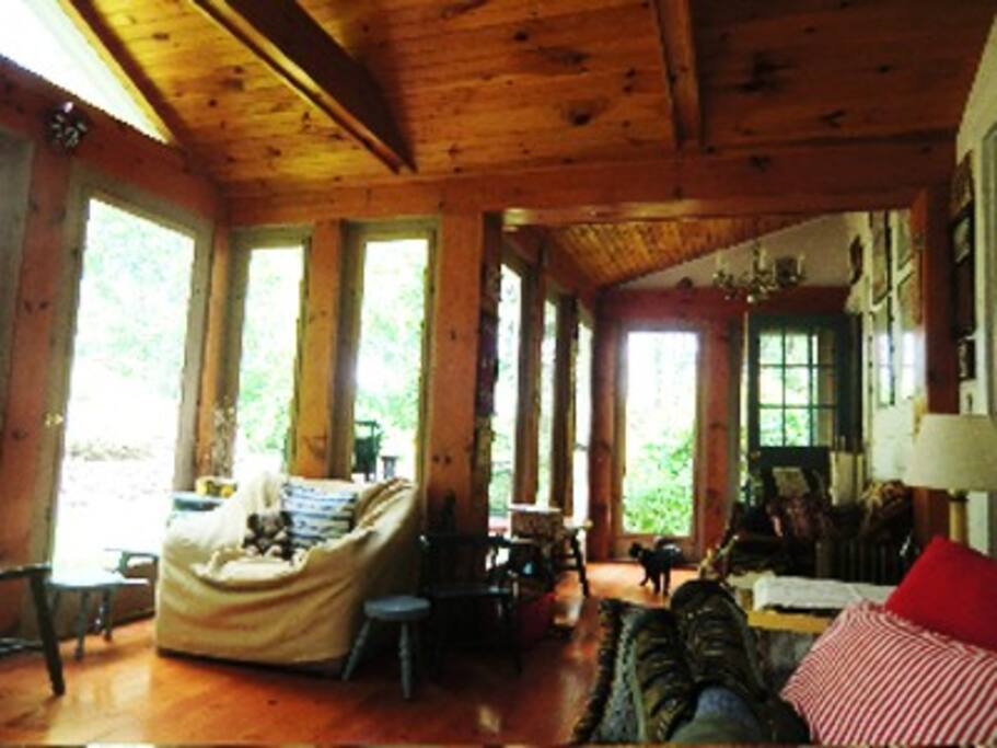 big porch facing gardens, with futon for sleeping and second large dining table