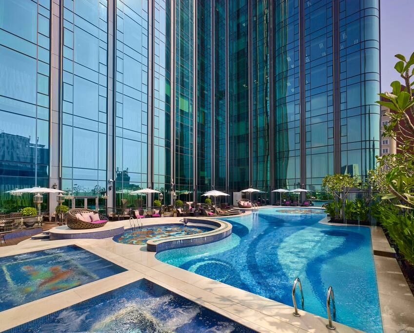 Outdoor swimming pool featuring mosaic.