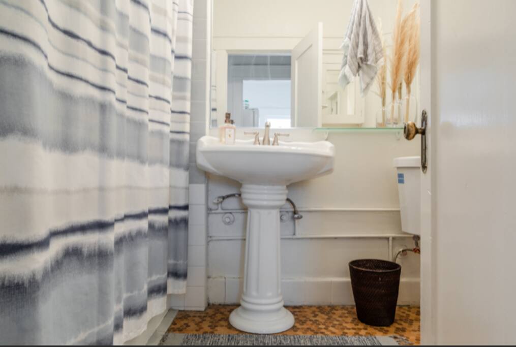 Fully renovated bathroom with quaint decor touches.
