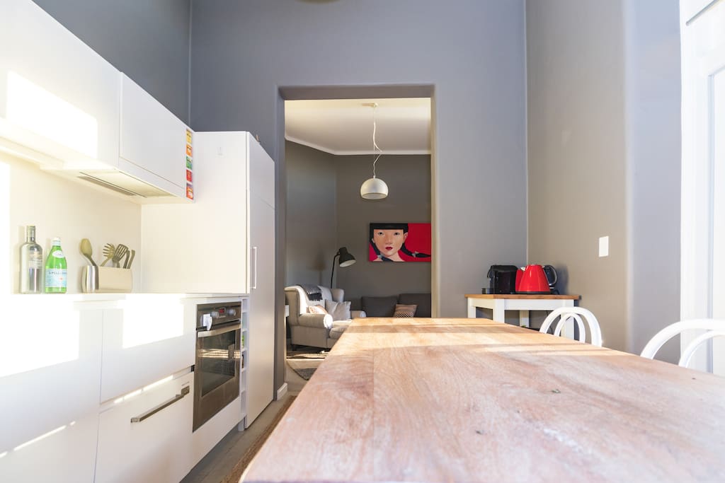 Functional kitchen and dining zone with Nespresso machine and fridge stocked with food and beverages for your enjoyment