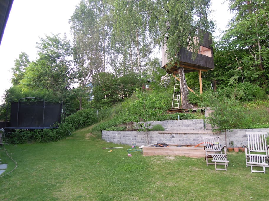 A large trampoline, treehouse and sandpit for the children