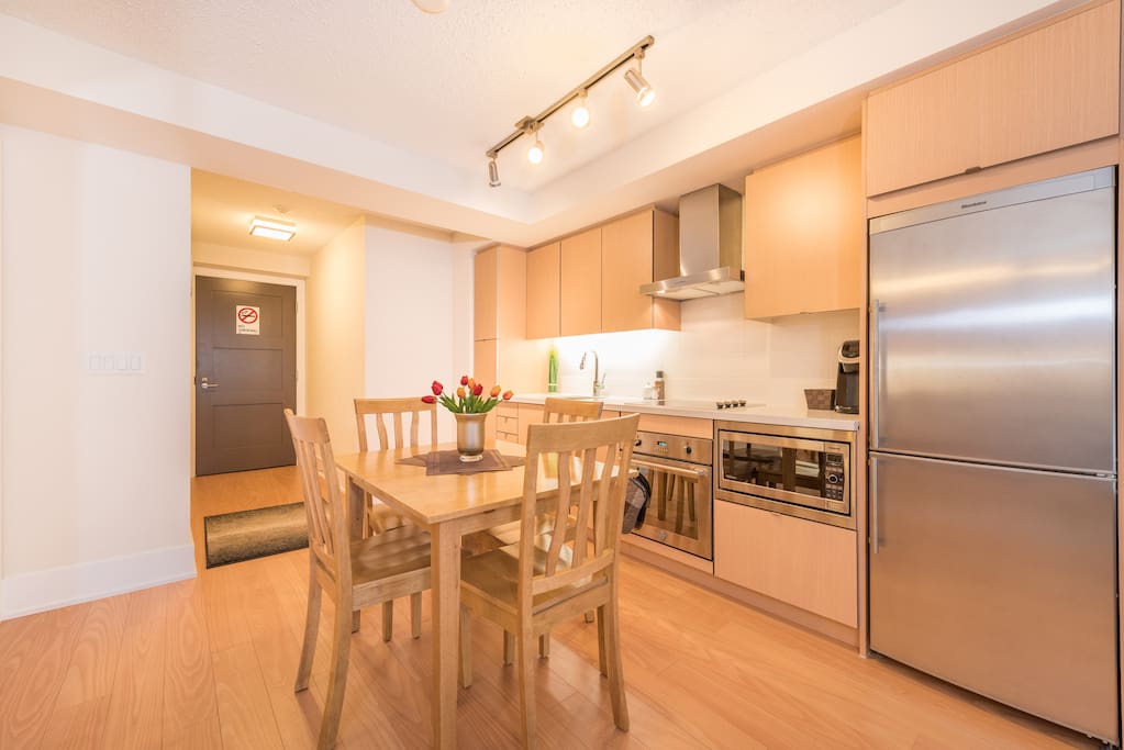 Dining space with table and kitchen