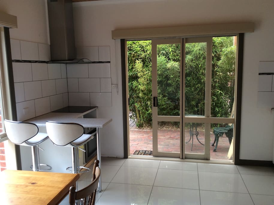Open plan kitchen with oven and electric cooktop on this side