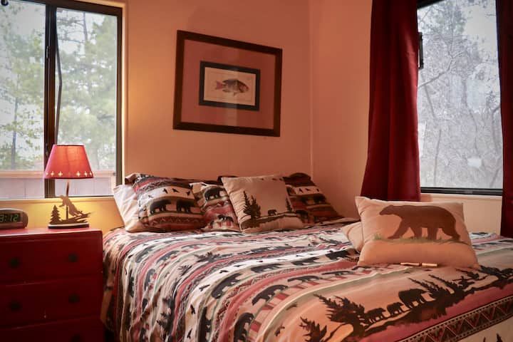 Bedroom #1: Downstairs rustic bedroom with a cozy new queen Serta mattress, wood floor, clothing rack with drawers, & beautiful views of Snow Summit ski resort.