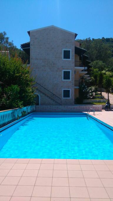 Swimming pool right next to apartment which is the ground floor window