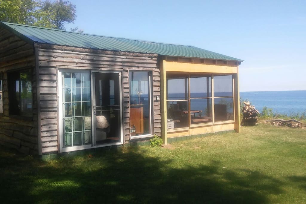 The glass surrounded love shack with a screened in porch.