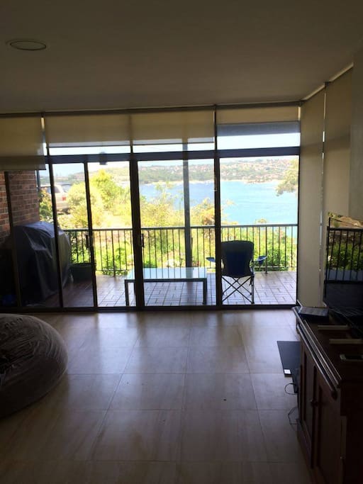 Large spacious living area complete with TV and dining table.