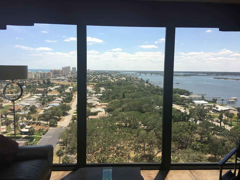 This is the southern view from the floor to ceiling windows in the living room. At night you can see the Ponce Inlet lighthouse and lights on the bridge!