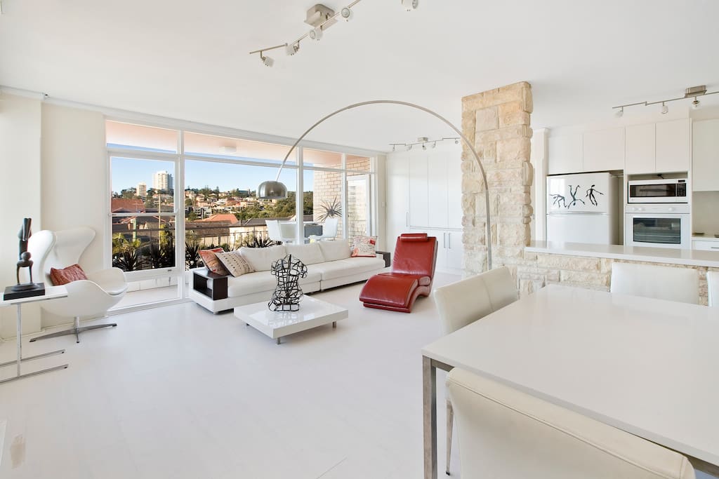 Large lounge room with view across the neighbourhood valley