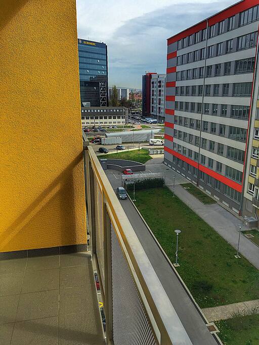 Balcony with one table and two chairs.
