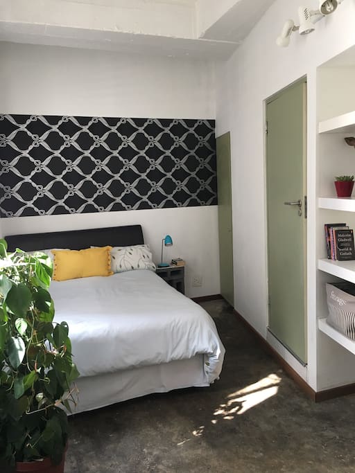 Comfortable double bed with leather headboard.