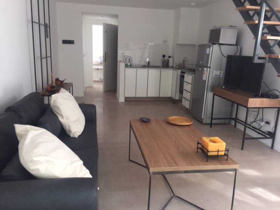 Fully equipped kitchen and living room area.