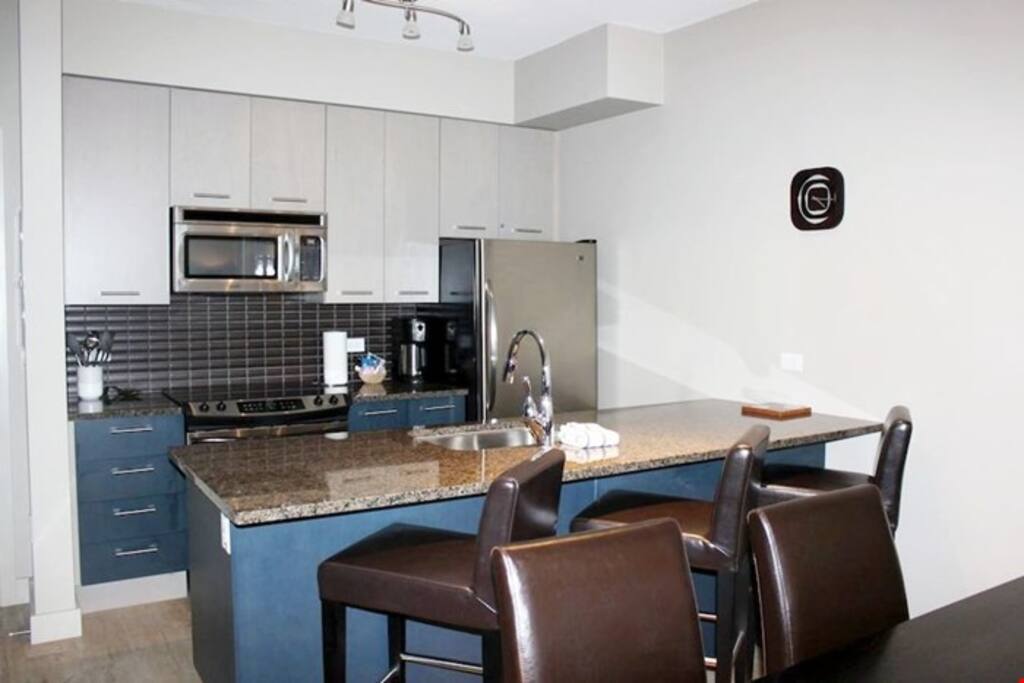 Cook meals with ease in the fully-equipped kitchen, complete with breakfast bar and stool seating.