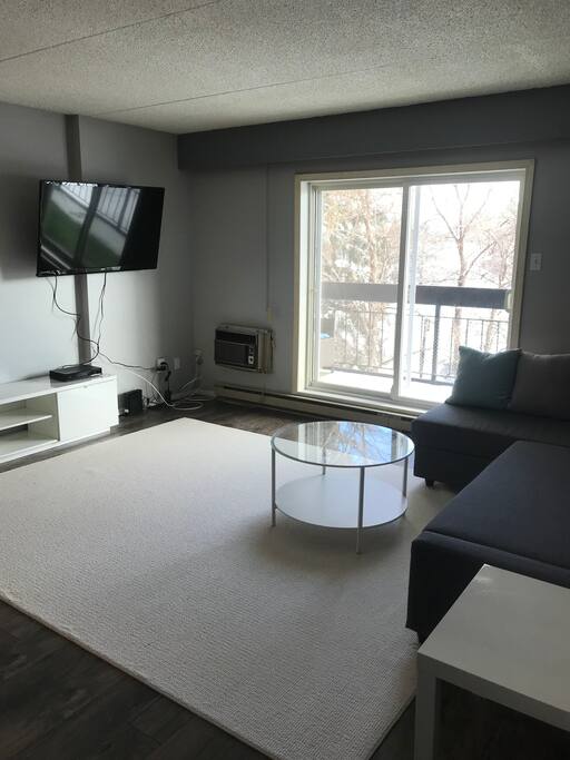 The living room, sliding patio doors lead to open balcony.