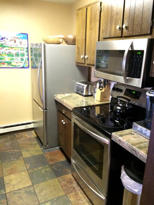 Kitchen with new stainless steel appliances.