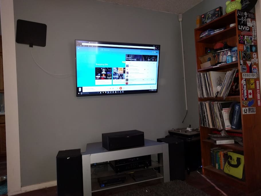 4K TV on the wall in living room with Media Library.