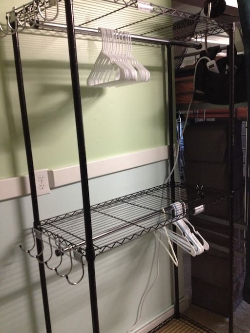 Top bunks have reserved clothes hanging rack direct next to bed labeled "TOP"