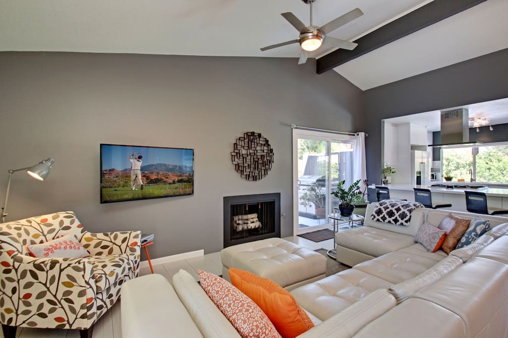 A spacious L-shaped couch and armchair offer seating in the bright living room