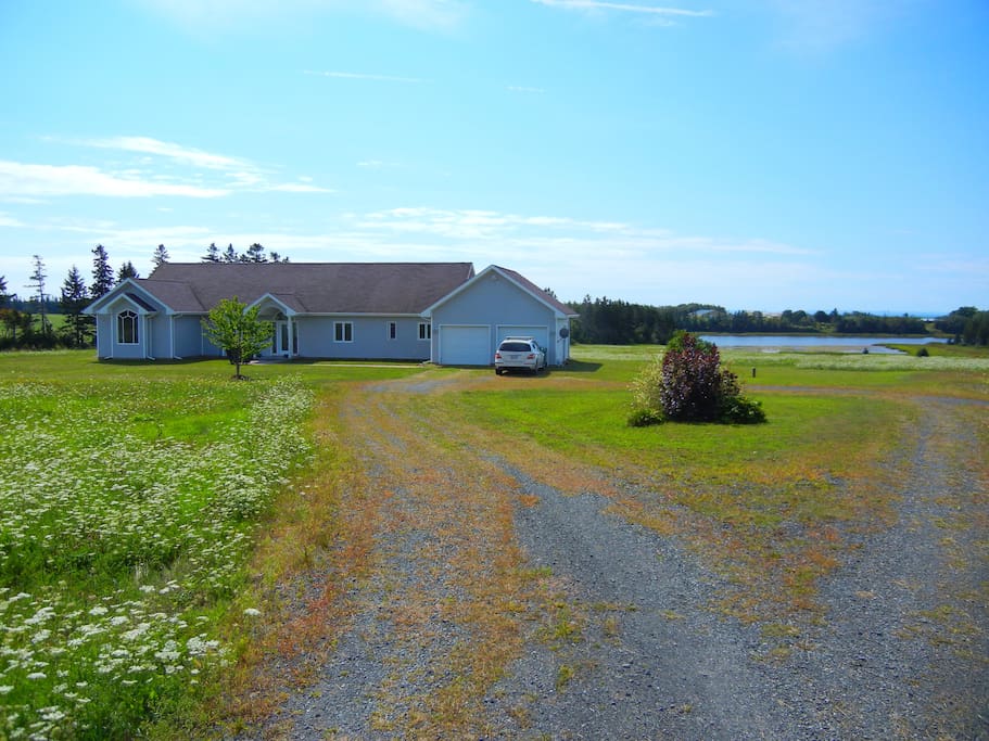 The house from the highway side as you make your way down the driveway. Set well back from the road for added serenity!