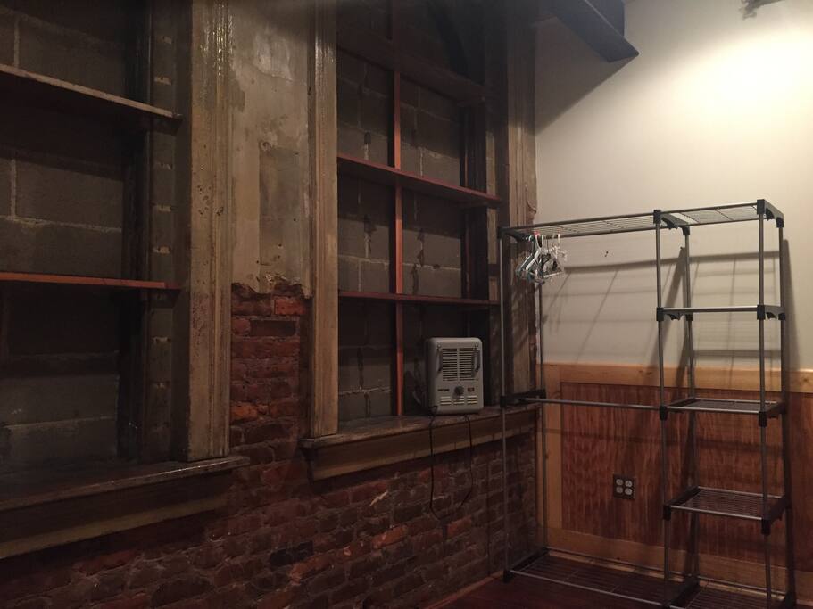 Bookshelves, heater, closet with hangers