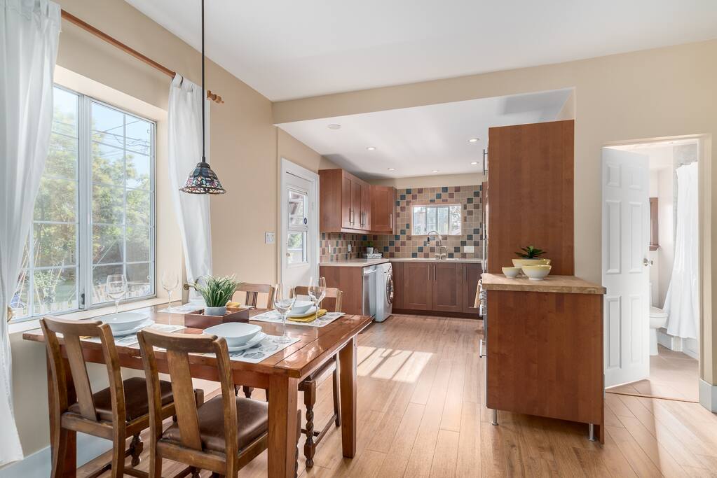 Double-expanding dining table and extra chairs and bench available to seat 12-14 people