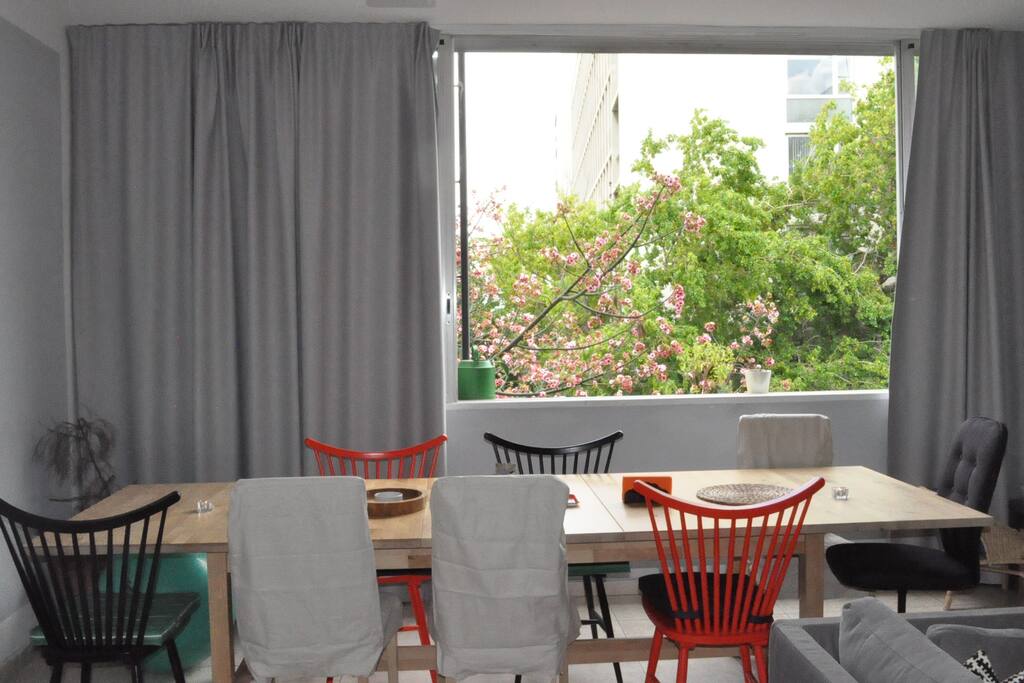 Table for dinner party hosting (kitchen complete with modern appliances for cooking).
