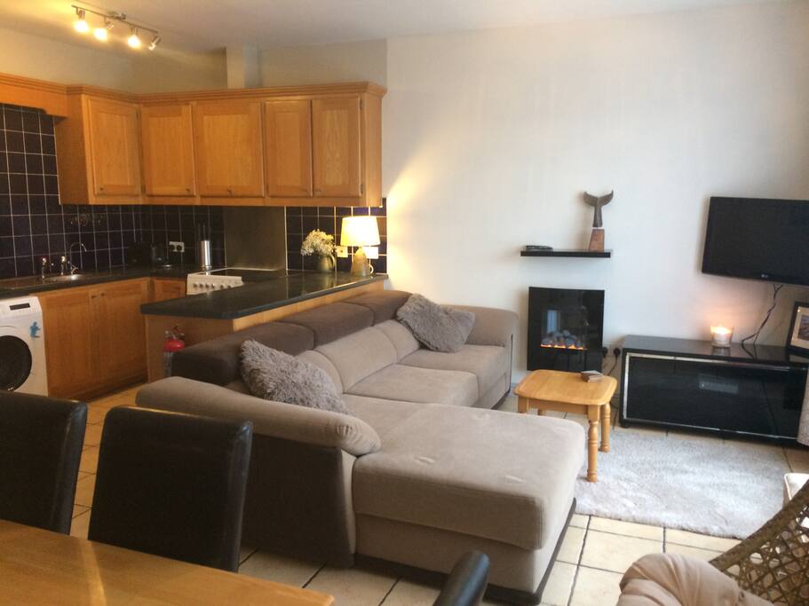 Open plan main living area solid oak kitchen, dinning area, comfy L shape couch