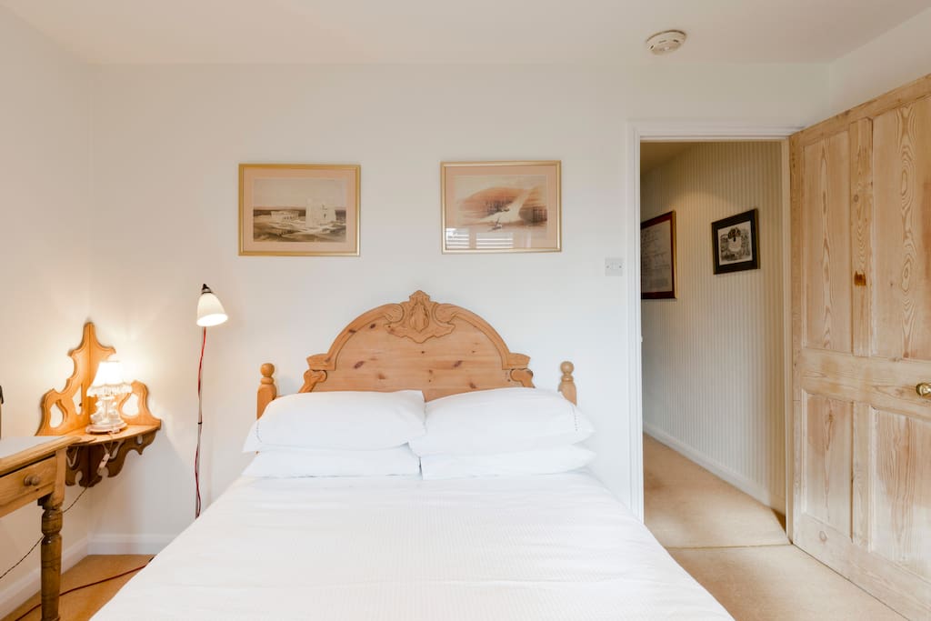 Comfortable double bed. En-suite bathroom is through door on the left