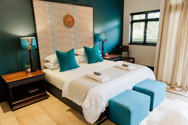 Downstairs bedroom with king size bed, luxury linen, down duvets on chilly nights and soft and firm pillows.