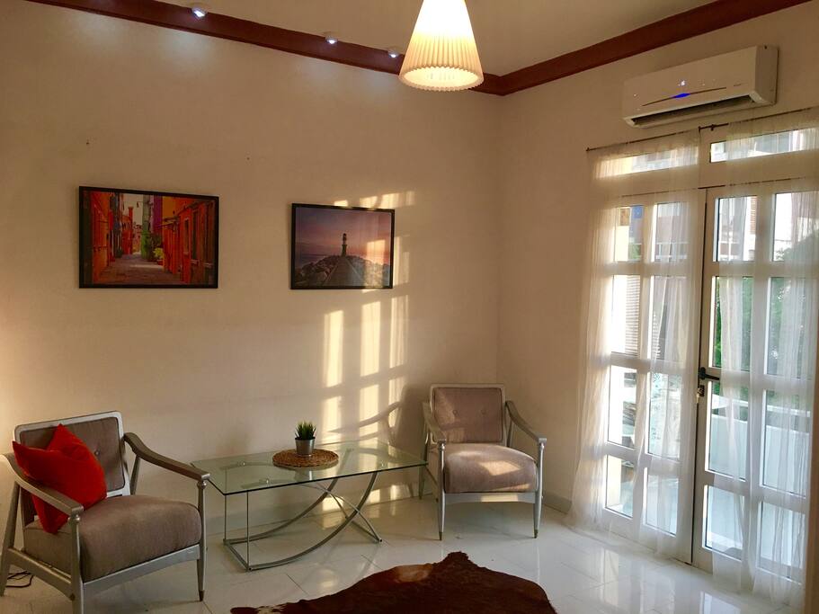 Art deco living room furniture with central AC, opens up to a large private balcony for outstanding sunsets of Havana!