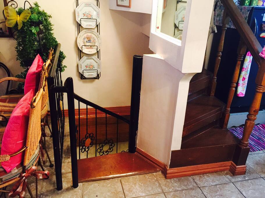 Spiral stair going to 2 bedrooms and bathrooms