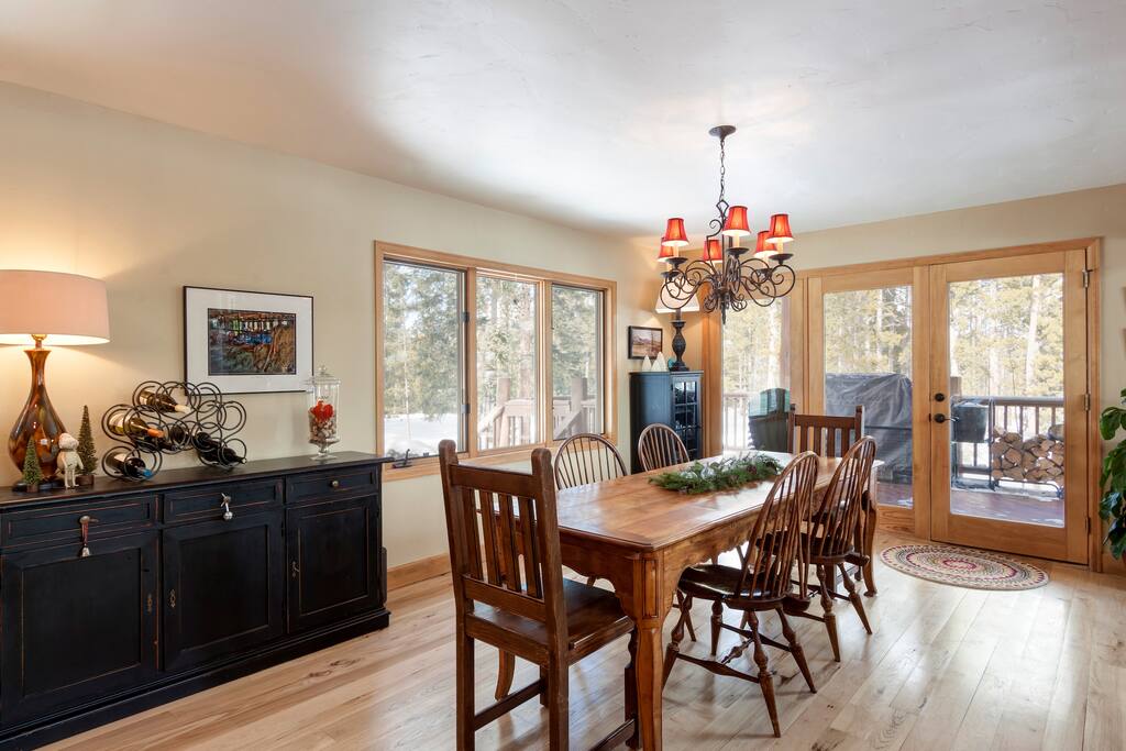 Dining area next to kitchen with views to nordic center, preak 8, and a deck with huge grill.