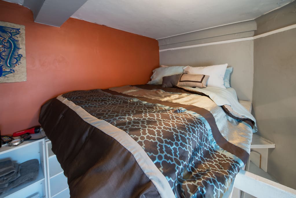Cozy lofted queen size bed with shelf stairs and plenty of space and tons of storage for longer visits!
