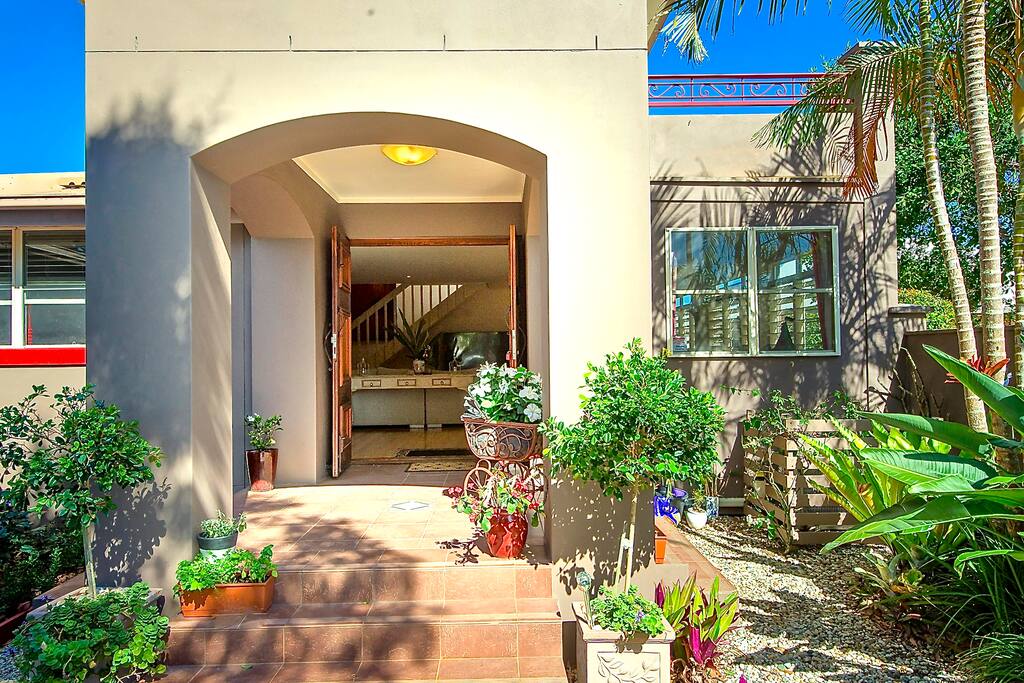 Enter through pretty gardens and potted herbs