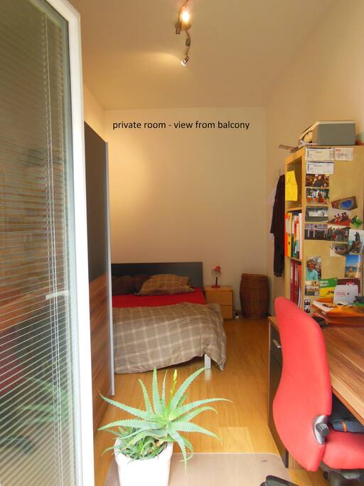 private sleeping room with desk and exit to the balcony