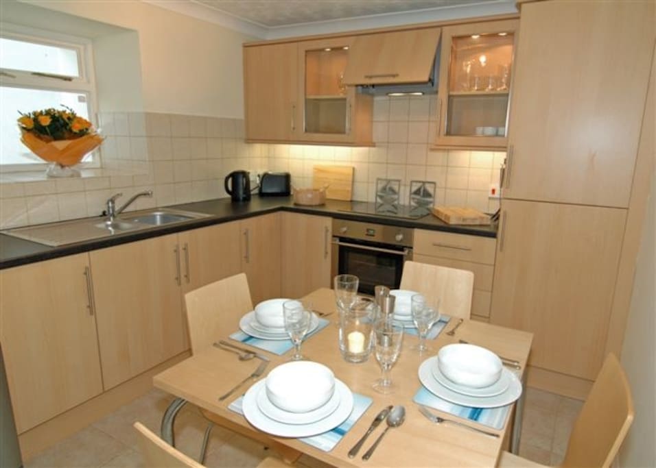 Kitchen with table for 4, fridge freezer, dishwasher and washing machine