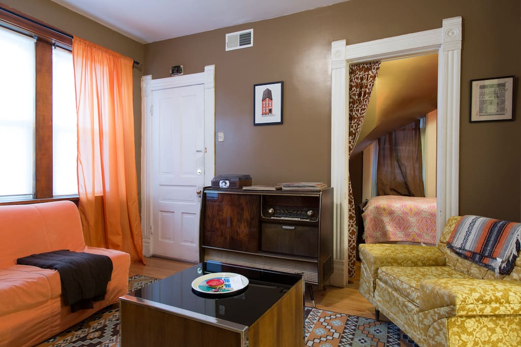 View of the living room from the kitchen. Mix a drink at the bar while spinning a record