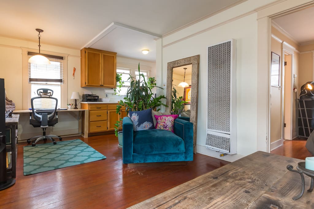 A spacious, colorful and wide open arrangement of beautiful furniture, light and plant life creates a cozy and comfortable living space.