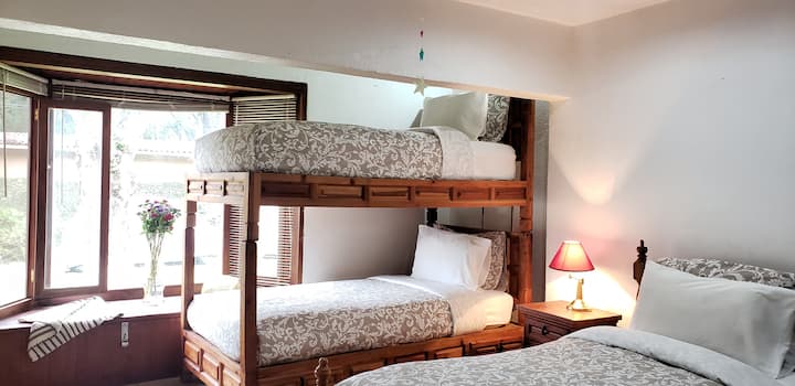 غرفة نوم داخلية بثلاثة أسرّة فردية.