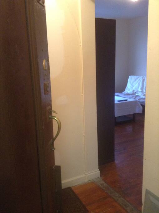 This is the front door entrance. The futon couch/bed is seen in the photo in the living room where you'll be staying. As you can see, there is plenty of lighting from the window during the day.