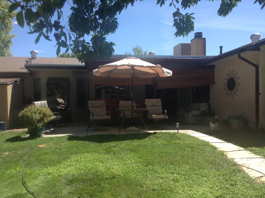 Back yard with grill, hot tub and patio set.