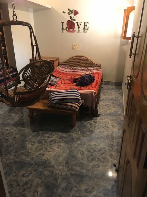 Bed room with a cane swing.